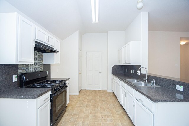 kitchen featuring lofted ceiling, sink, tasteful backsplash, gas stove, and white cabinetry