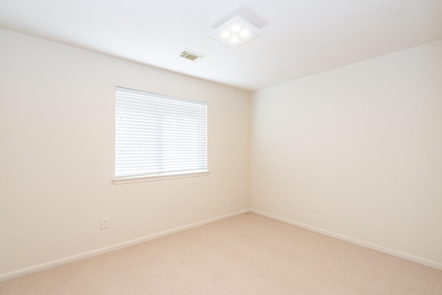 empty room featuring light carpet