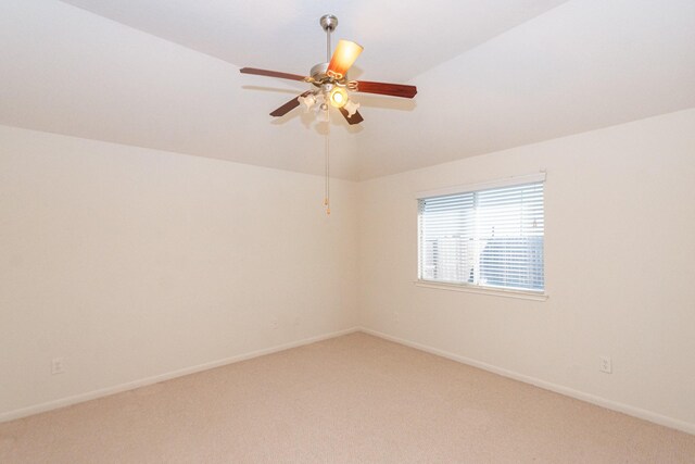 empty room featuring carpet, ceiling fan, and lofted ceiling