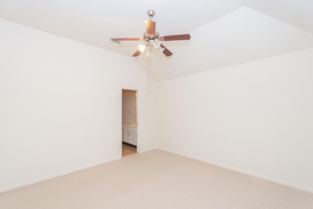 carpeted spare room featuring ceiling fan and lofted ceiling