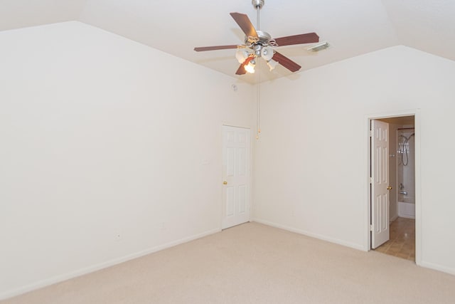 carpeted spare room featuring ceiling fan and lofted ceiling