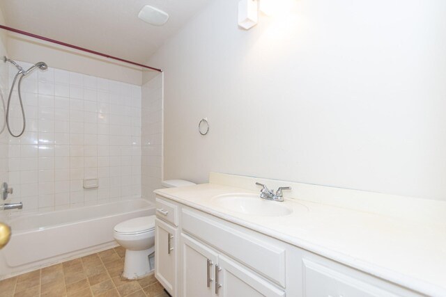 full bathroom with vanity, toilet, and tiled shower / bath