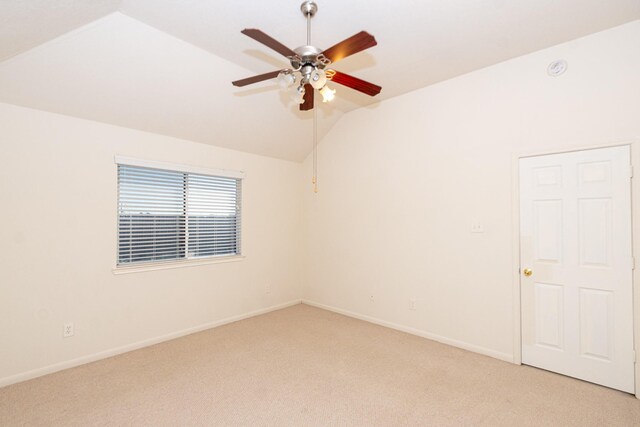 carpeted spare room featuring ceiling fan and lofted ceiling