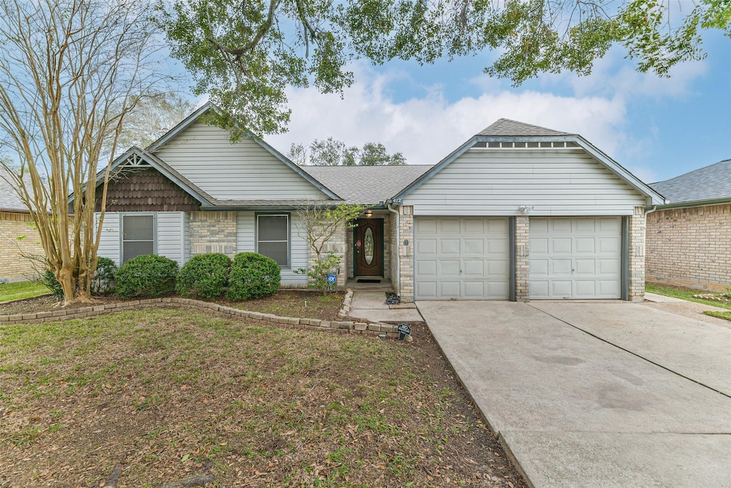 ranch-style house with a front yard and a garage