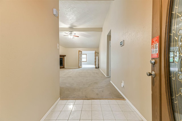 corridor with light colored carpet and vaulted ceiling