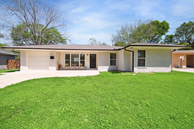 single story home with a front lawn, covered porch, and a garage