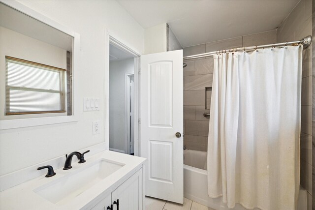 bathroom with tile patterned flooring, vanity, and shower / tub combo with curtain