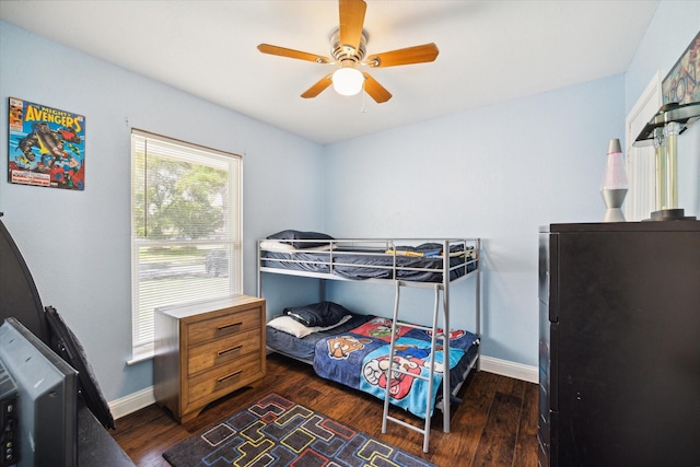 bedroom with ceiling fan and dark hardwood / wood-style floors