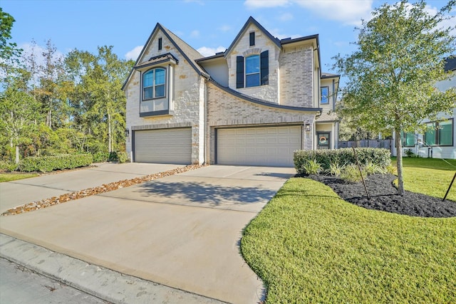 view of front of house with a garage and a front lawn