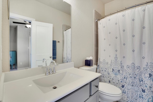 bathroom with vanity, toilet, curtained shower, and ceiling fan