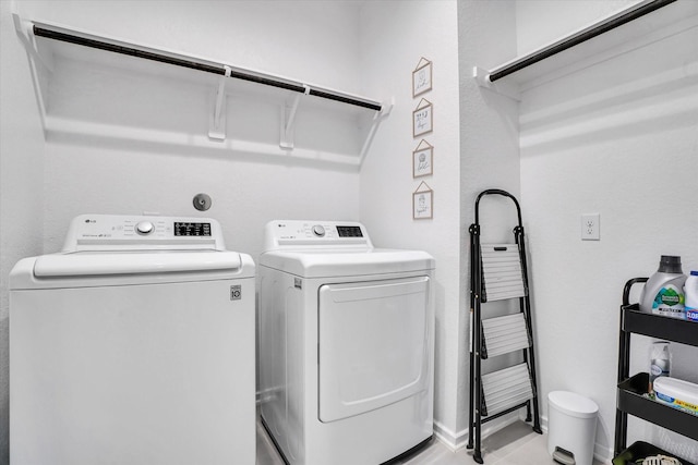 clothes washing area featuring washer and dryer