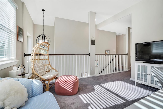 carpeted living room featuring lofted ceiling