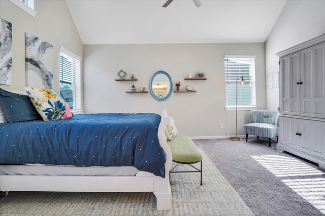 carpeted bedroom with ceiling fan and vaulted ceiling