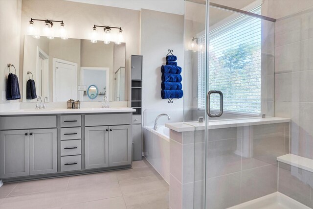 bathroom featuring tile patterned floors, plus walk in shower, and vanity