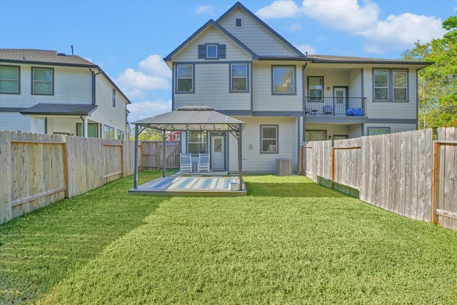 rear view of house with a gazebo, a yard, central air condition unit, and a wooden deck