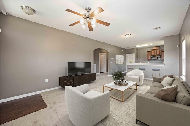 carpeted living room featuring ceiling fan