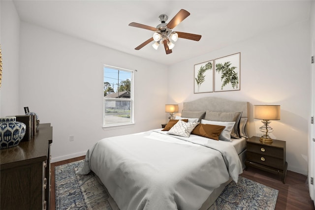 bedroom with ceiling fan and dark hardwood / wood-style flooring