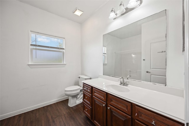 bathroom featuring hardwood / wood-style flooring, vanity, toilet, and a shower