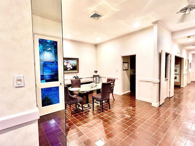 tiled dining area with crown molding