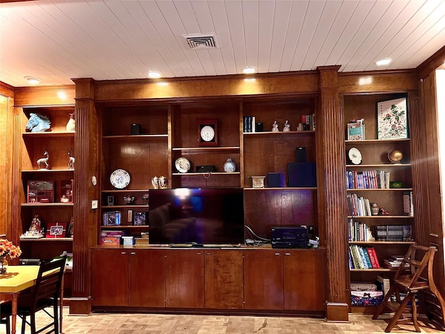 office with built in shelves and wood ceiling