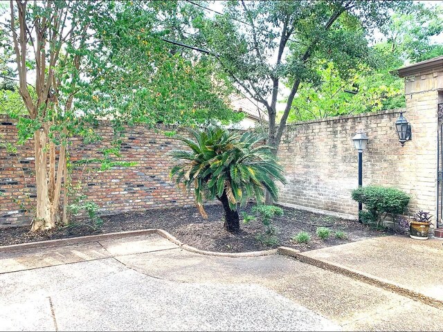 view of gate featuring a patio