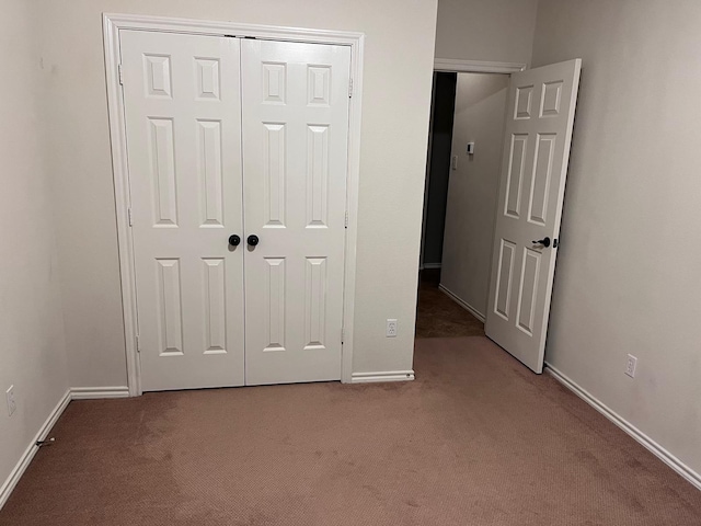 unfurnished bedroom featuring a closet and carpet floors