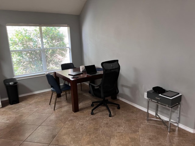 home office with tile patterned floors and vaulted ceiling