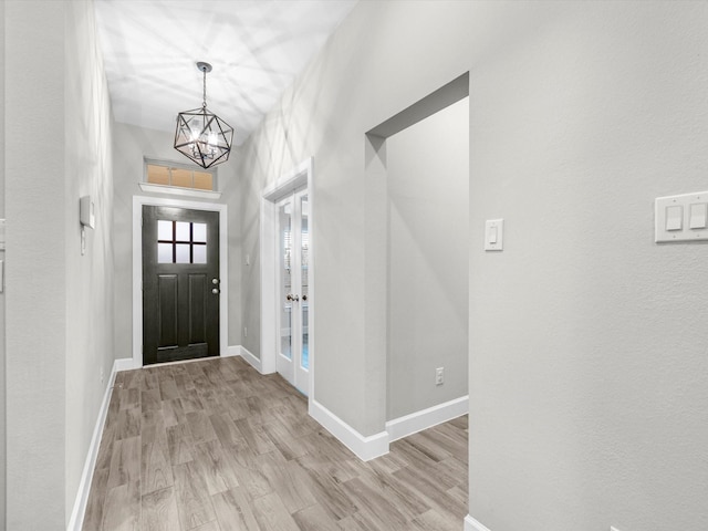 entrance foyer with an inviting chandelier and light wood-type flooring