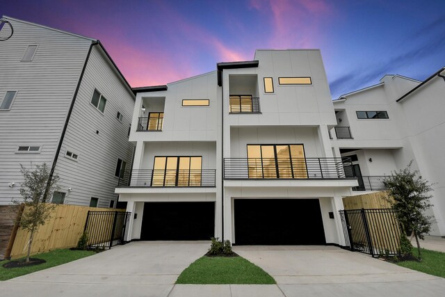 contemporary house featuring a balcony and a garage