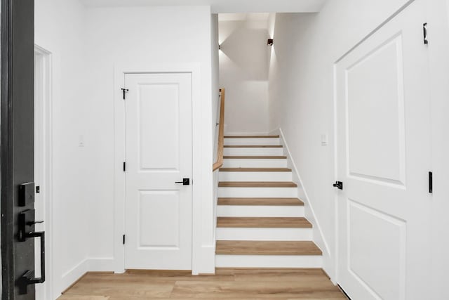 staircase with wood-type flooring