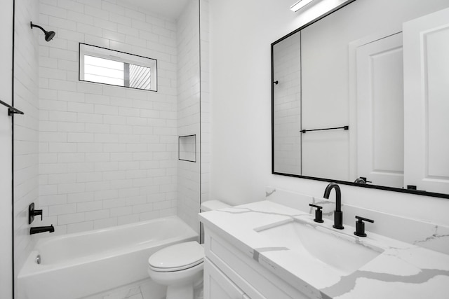 full bathroom featuring tiled shower / bath, vanity, and toilet