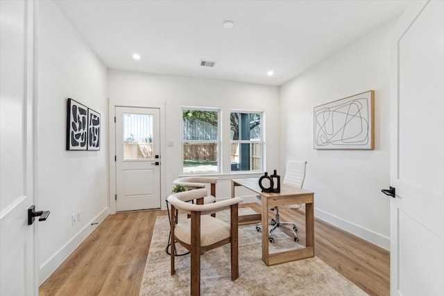 home office with light hardwood / wood-style floors