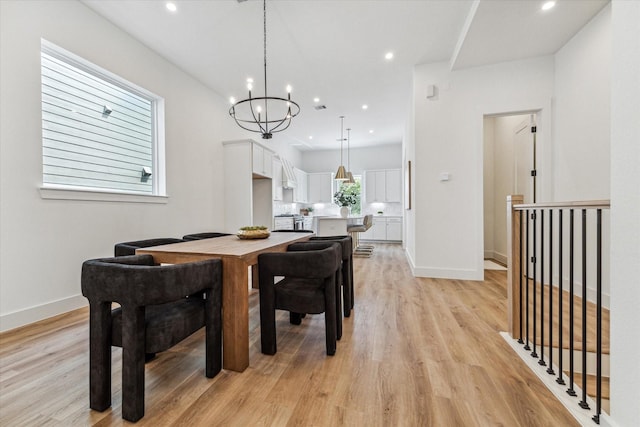 dining area featuring light hardwood / wood-style floors and a chandelier