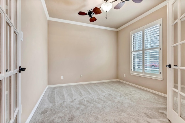 empty room featuring light colored carpet, french doors, ceiling fan, and crown molding