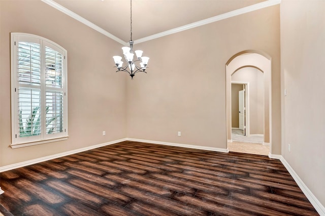 spare room featuring crown molding, dark hardwood / wood-style floors, and plenty of natural light