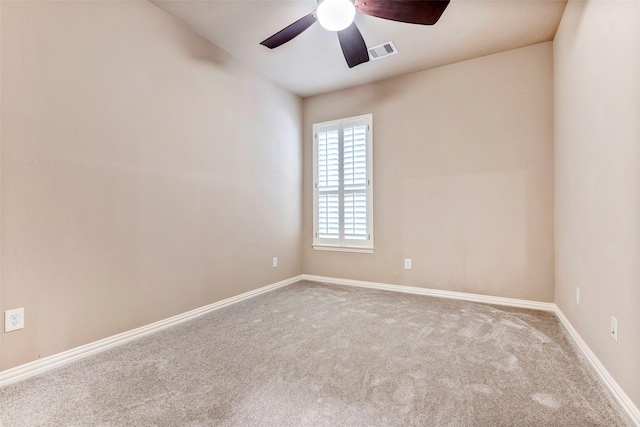 empty room featuring ceiling fan and light colored carpet