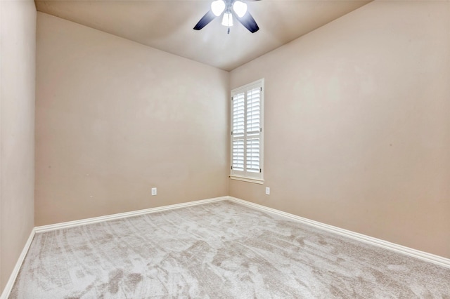 carpeted spare room with ceiling fan