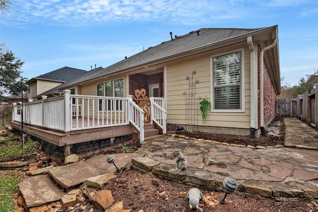 back of property with a patio and a wooden deck