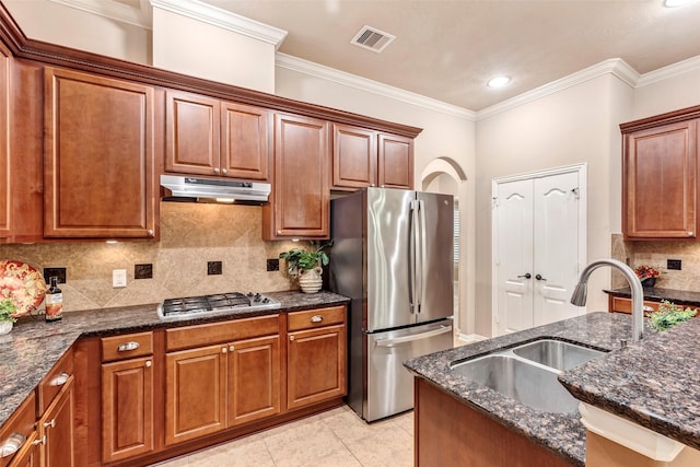 kitchen with appliances with stainless steel finishes, ornamental molding, backsplash, and sink