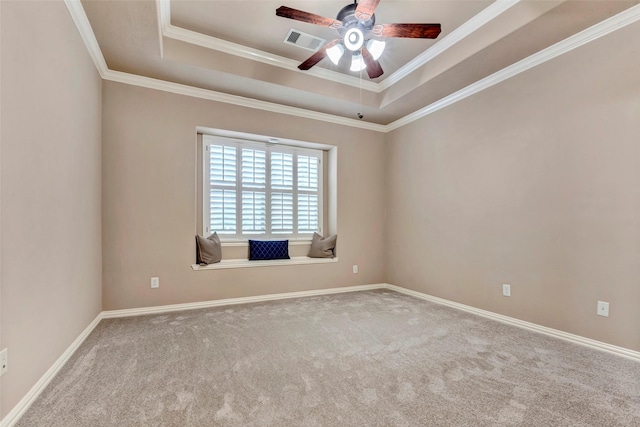 carpeted empty room featuring ornamental molding, a raised ceiling, and ceiling fan