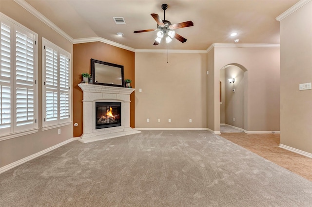 unfurnished living room with ornamental molding, light colored carpet, ceiling fan, and vaulted ceiling