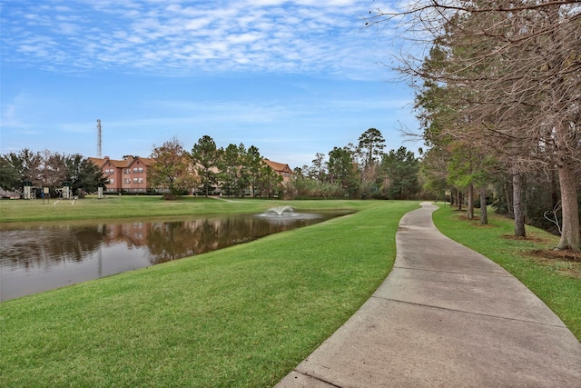 view of property's community featuring a yard and a water view