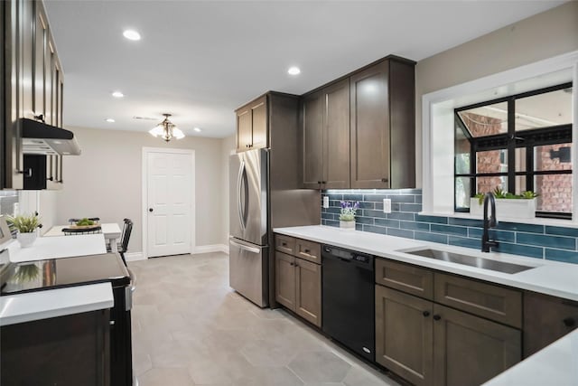 kitchen with dishwasher, sink, a notable chandelier, stainless steel fridge, and electric stove