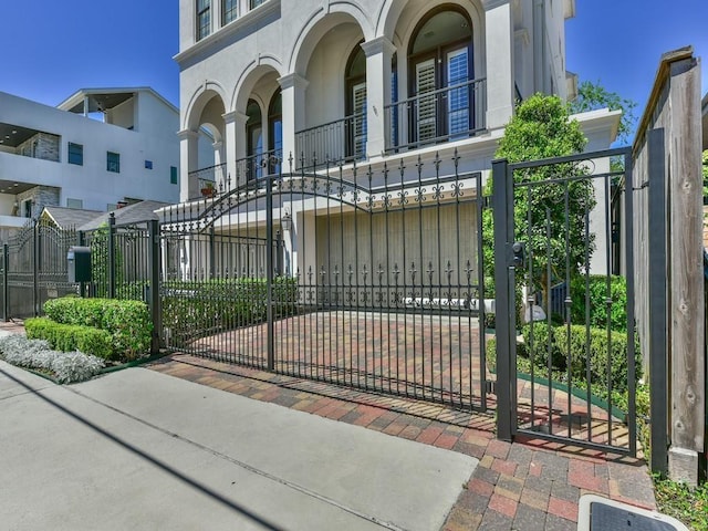 view of gate with a fenced front yard