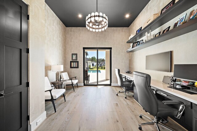 home office featuring light hardwood / wood-style floors and a notable chandelier