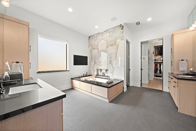 bathroom with a washtub and vanity