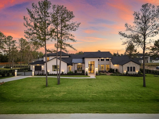 view of front of house with a garage and a yard