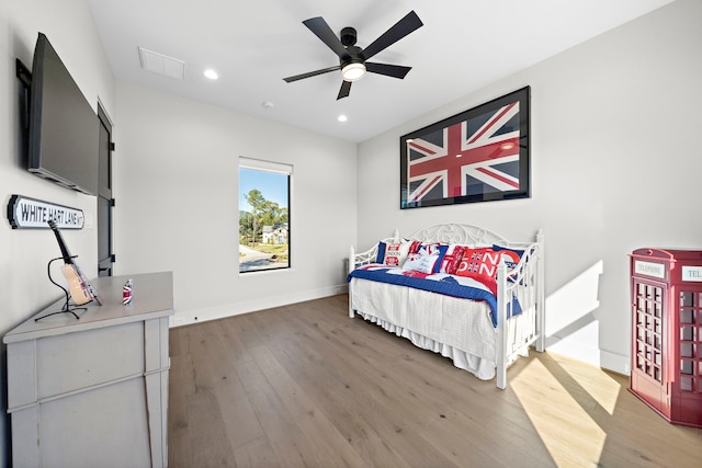 bedroom with ceiling fan and hardwood / wood-style flooring