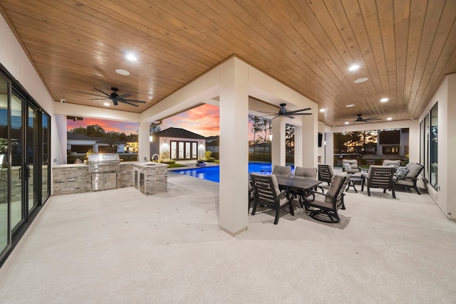 patio terrace at dusk featuring area for grilling and grilling area