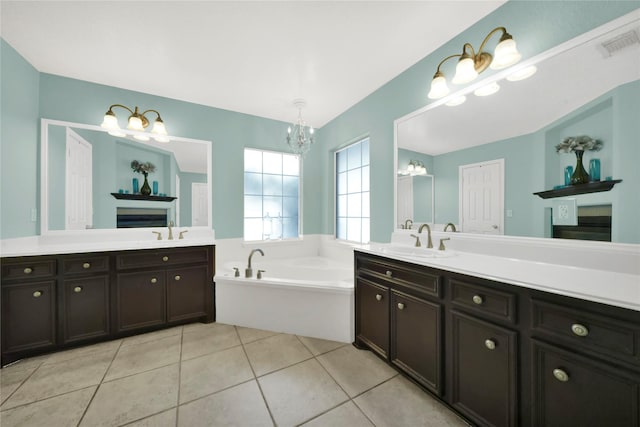 bathroom with a bathing tub, tile patterned flooring, and vanity